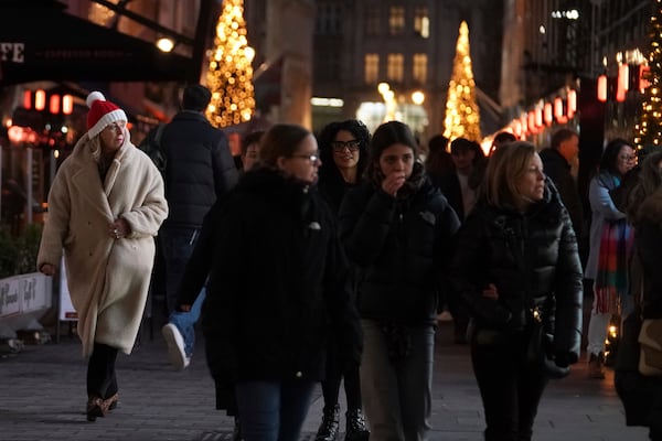 Christmas shoppers in central London, Friday, Dec. 13, 2024, Britain's economy unexpectedly shrank by 0.1 percent in October, The Office for National Statistics stated in figures released Friday. (AP Photo/Alberto Pezzali)