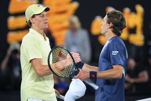 Jannik Sinner, left, of Italy is congratulated by Alex de Minaur of Australia following their quarterfinal match at the Australian Open tennis championship in Melbourne, Australia, Wednesday, Jan. 22, 2025. (AP Photo/Vincent Thian)