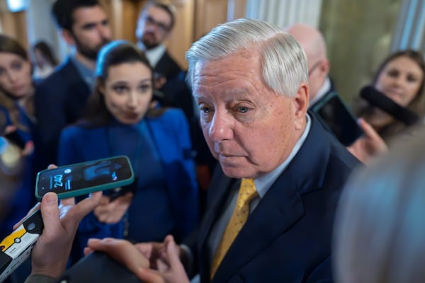 Sen. Lindsey Graham, R-S.C., chairman of the Senate Budget Committee, is surrounded by reporters asking about his plans to move ahead with a spending bill, at the Capitol in Washington, Tuesday, Feb. 11, 2025. (AP Photo/J. Scott Applewhite)