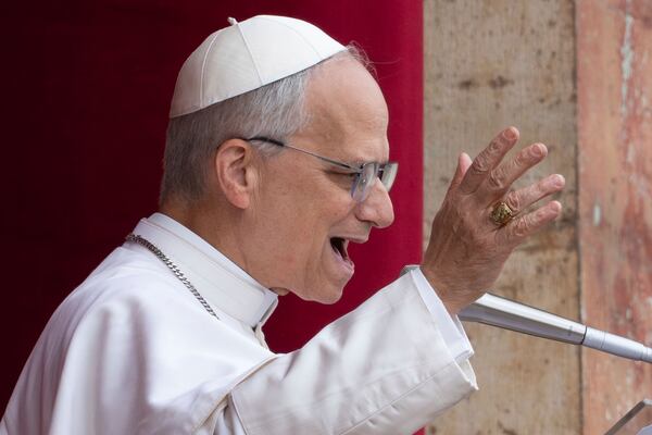 Pope Leo XIV speaks from the central balcony of St. Peter's Basilica from where he delivered his first Sunday blessing since his election to the faithful gathered in St. Peter's Square for the traditional Regina Caeli prayer at noon, on Sunday, May 11, 2025. (AP Photo/Domenico Stinellis)