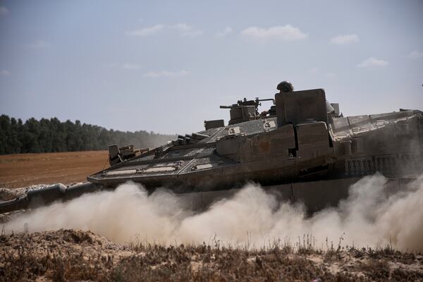 Israeli forces move along the border with the Gaza Strip, in southern Israel, Monday, May 19, 2025. (AP Photo/Ohad Zwigenberg)