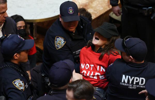 New York Police officers arrest a demonstrator from the group, Jewish Voice for Peace, who protested inside Trump Tower in support of Columbia graduate student Mahmoud Khalil, Thursday, March 13, 2025, in New York. (AP Photo/Yuki Iwamura)