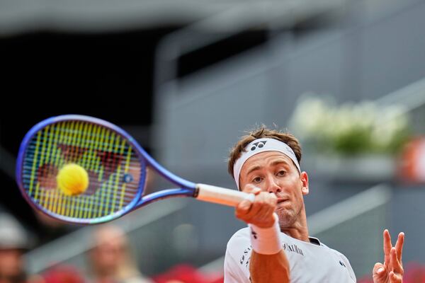 Casper Ruud of Norway returns the ball against Russia's Daniil Medvedev during the Madrid Open tennis tournament in Madrid, Spain, Thursday, May 1, 2025. (AP Photo/Manu Fernandez)