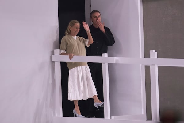 FILE - Head designers Miuccia Prada, left, and Raf Simons acknowledge the applause of the audience at the end of the Prada Spring Summer 2025 fashion show, that was presented in Milan, Italy, Sunday, June 16, 2024. (AP Photo/Luca Bruno, File)