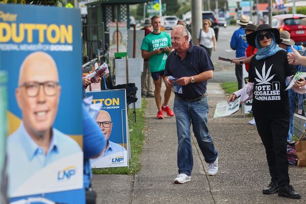 A man walks into a polling station in Brisbane, Australia, Saturday, May 3, 2025. (AP Photo/Pat Hoelscher)
