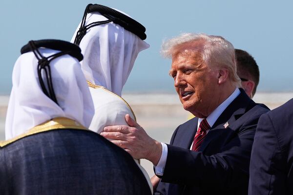 President Donald Trump is greeted by Qatar's Emir Sheikh Tamim bin Hamad Al Thani as he arrives on Air Force One at Hamad International Airport in Doha, Qatar, Wednesday, May 14, 2025. (AP Photo/Alex Brandon)