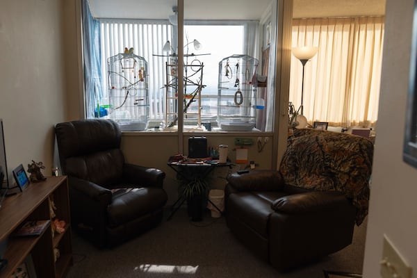 Phyllis Goss' birds sit on a cage inside her studio apartment at Smith Tower Apartments on Monday, March 10, 2025, in Vancouver, Wash. (AP Photo/Jenny Kane)