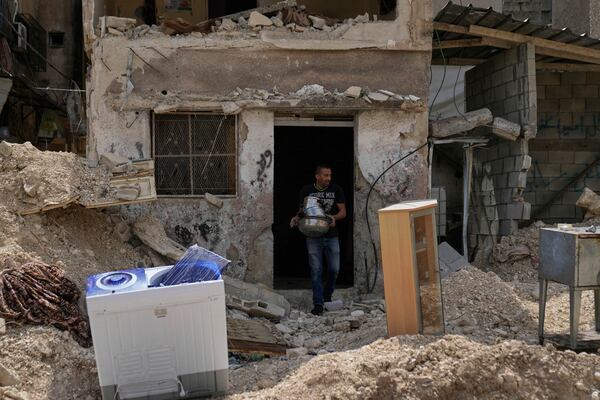 Residents of the now evacuated refugee camp of Tulkarem return to collect belongings before the destruction of their homes as Israeli forces prepare to carry out the demolition of 116 homes across the two refugee camps of the Israeli occupied West Bank city of Tulkarem, Friday, May 2, 2025. (AP Photo/Nasser Nasser)