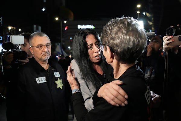 FILE - Einav Zangauker, center, is embraced by freed hostage Yocheved Lifshitz before making a statement about a Hamas video of her son, Israeli hostage Matan Zangauker, in Tel Aviv, Israel, Saturday, Dec. 7, 2024. (AP Photo/Mahmoud Illean, File)