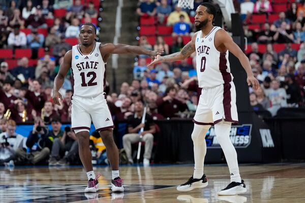 Mississippi State guard Josh Hubbard (12) celebrates with guard Claudell Harris Jr. (0) after making a three-point shot during the first half in the first round of the NCAA college basketball tournament against Baylor, Friday, March 21, 2025, in Raleigh, N.C. (AP Photo/Stephanie Scarbrough)