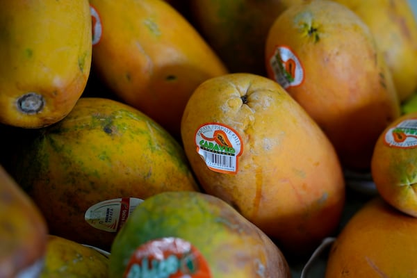 Papayas for sale are displayed at a grocery store in San Francisco, Wednesday, March 5, 2025. (AP Photo/Jeff Chiu)