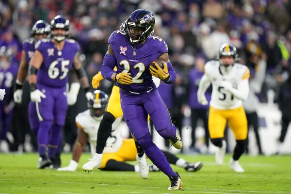 Baltimore Ravens running back Derrick Henry runs with the ball against the Pittsburgh Steelers during the first half of an NFL football game, Saturday, Dec. 21, 2024, in Baltimore. (AP Photo/Stephanie Scarbrough)