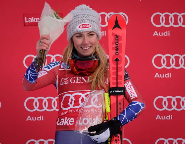 FILE - Mikaela Shiffrin, of the United States, celebrates her victory on the podium following the women's World Cup downhill skiing action in Lake Louise, Alberta, Saturday, Dec. 2, 2017. (Jeff McIntosh/The Canadian Press via AP, File)