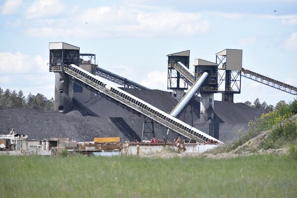A pile of coal, conveyor belts and towers for moving and storing coal are seen at Signal Peak Energy's Bull Mountains Mine, on May 21, 2025, near Roundup, Montana. (AP Photo/Matthew Brown)