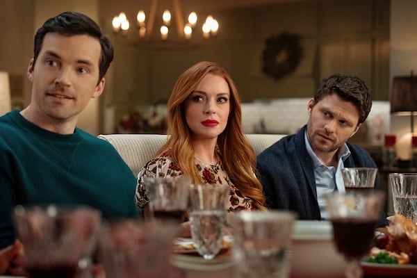 This image released by Netflix shows Ian Harding, from left, Lindsay Lohan and Jon Rudnitsky in a scene from "Our Little Secret." (Bob Mahoney/Netflix via AP)