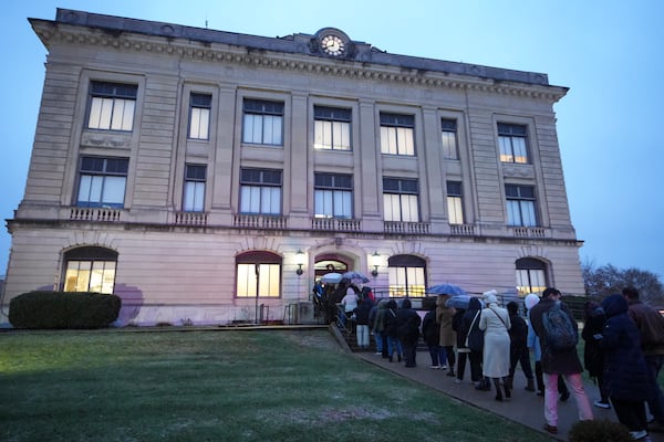 Spectators line up to enter the Carroll County Courthouse for the sentencing of Richard Allen, convicted in the 2017 killings of two teenage girls , in Delphi, Ind., Friday, Dec. 20, 2024. (AP Photo/Michael Conroy)