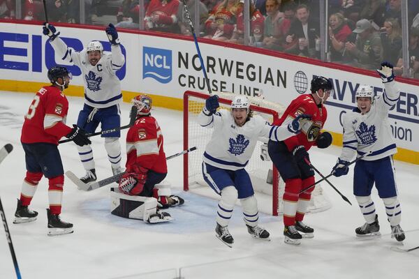 Toronto Maple Leafs players celebrate a goal by defenseman Morgan Rielly during the third period in Game 3 of a second-round NHL hockey playoff series against the Florida Panthers, Friday, May 9, 2025, in Sunrise, Fla. (AP Photo/Marta Lavandier)