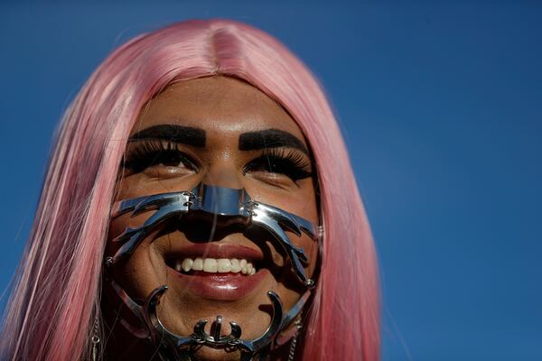 A fan dons a punk mechanical face mask while waiting for the start of Lady Gaga's free concert on Copacabana beach in Rio de Janeiro, Saturday, May 3, 2025. (AP Photo/Bruna Prado)