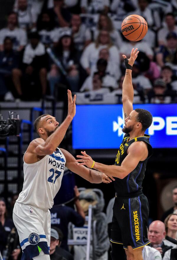 Stephen Curry (30) shoots over Rudy Gobert (27) in the first half as the Golden State Warriors played the Minnesota Timberwolves in Game 1 of the Second Round of the NBA Playoffs at Target Center in Minneapolis, Minn., on Tuesday, May 6, 2025. ( Carlos Avila Gonzalez/San Francisco Chronicle via AP)