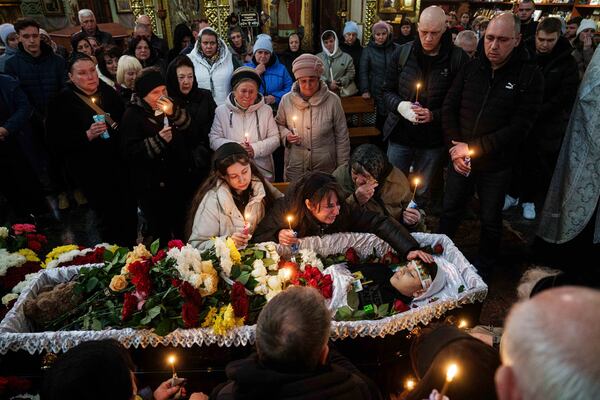 FILE- A mother cries over the coffin of her son Herman Tripolets, 9, killed by a Russian missile, during a funeral ceremony in Kryvyi Rih, Ukraine, April 7, 2025. (AP Photo/Evgeniy Maloletka, File)