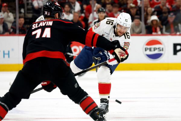 Florida Panthers' Aleksander Barkov (16) clears the puck past Carolina Hurricanes' Jaccob Slavin (74) during the first period of Game 5 of the NHL hockey Stanley Cup Eastern Conference finals in Raleigh, N.C., Wednesday, May 28, 2025. (AP Photo/Karl DeBlaker)