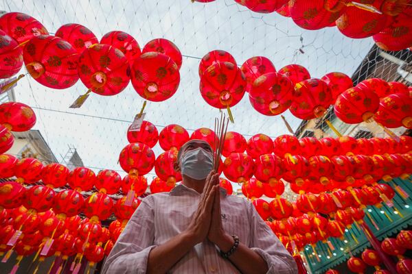 An Ethnic Chinese Thai prays at Kwong Siew Shrine to celebrate the Lunar New Year in Bangkok, Thailand, Wednesday, Jan. 29, 2025. (AP Photo/Sakchai Lalit)