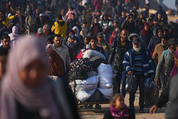 Displaced Palestinians walk on a road to return to their homes in the northern Gaza Strip, Tuesday, Jan. 28, 2025, after Israel's decision to allow thousands of them to go back for the first time since the early weeks of the 15-month war with Hamas. (AP Photo/Abdel Kareem Hana)