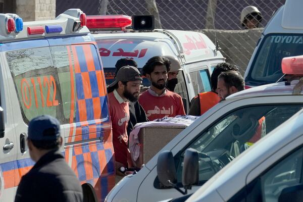 Rescue workers transport a coffin containing the body of a victim from a passenger train attacked by insurgents, upon arrival at a railway station in Much, Pakistan's southwestern Balochistan province, Thursday March 13, 2025. (AP Photo/Anjum Naveed)