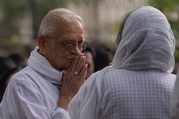 Indian film maker and poet Gulzar, left, pay homage to Shyam Benegal, a renowned Indian filmmaker who passed away on Monday, during Benegal's funeral in Mumbai, India, Tuesday, Dec. 24, 2024. (AP Photo/Rafiq Maqbool)