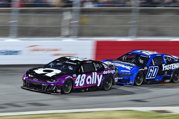 Alex Bowman (48) and Ryan Preece (60) compete into Turn 1 during a NASCAR Cup Series auto race at Bowman Gray Stadium, Sunday, Feb. 2, 2025, in Winston-Salem, N.C. (AP Photo/Matt Kelley)