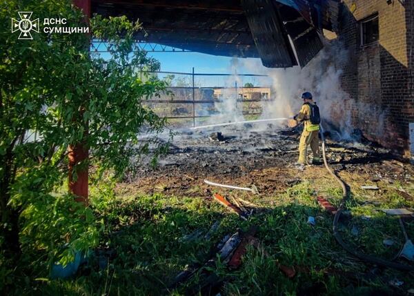 In this photo provided by the Ukrainian Emergency Services on May 8, 2025, a rescue worker puts out a fire of a building which was heavily damaged by a Russian strike in Sumy region, Ukraine. (Ukrainian Emergency Service via AP)