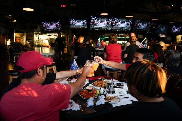 FILE -Supporters of former President Donald Trump drink beers as they watch him speak on television on Thursday, July 18, 2024, in Seal Beach, Calif. (AP Photo/Ashley Landis, File)