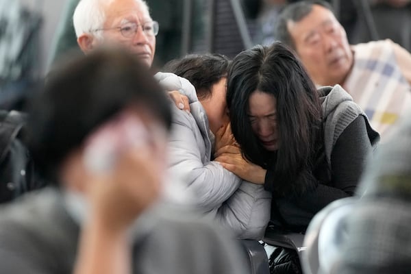 FILE - Relatives of passengers on a plane which skidded off a runway and burst into flames, react at Muan International Airport in Muan, South Korea, Monday, Dec. 30, 2024. (AP Photo/Ahn Young-joon, FILE)