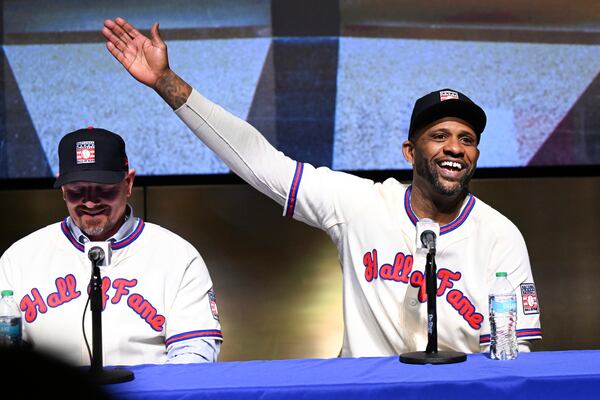 Newly-elected Baseball Hall of Fame inductee Billy Wagner, left, listens as CC Sabathia talks to reporters during a news conference Thursday, Jan. 23, 2025, in Cooperstown, N.Y. (AP Photo/Hans Pennink)