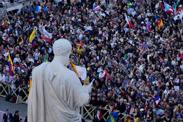 Crowds cheer in St. Peter's square after the election of the 267th pontiff of the Roman Catholic Church, at the Vatican, Thursday, May 8, 2025. (AP Photo/Gregorio Borgia)