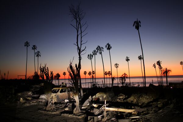 The devastation of the Palisades Fire is seen at sunset in the Pacific Palisades neighborhood of Los Angeles, Tuesday, Jan. 14, 2025. (AP Photo/Ethan Swope)