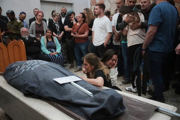 Mourners react next to the body of Tzeela Gez, 37, an Israeli who was on her way to have her baby delivered when she was shot and killed by a Palestinian gunman in the occupied West Bank, during her funeral at Givat Shaul cemetery in Jerusalem on Thursday, May 15, 2025. (AP Photo/Ohad Zwigenberg)