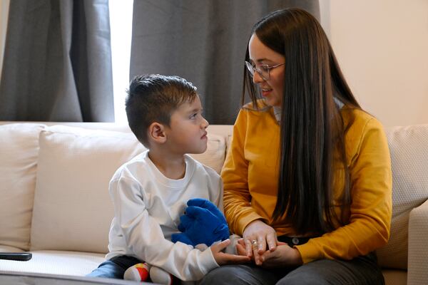 In this Jan. 3, 2025 photo, Karina Canizarez, right, talks with her son Jesus Lopez, in their apartment in New Milford, Conn. (AP Photo/Jessica Hill)