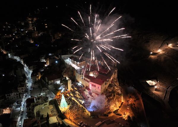 Fireworks burst over Saydnaya Convent during the lighting of the Christmas tree, in Saydnaya town on the outskirts of Damascus, Syria, Tuesday, Dec. 24, 2024. (AP Photo/Hussein Malla)