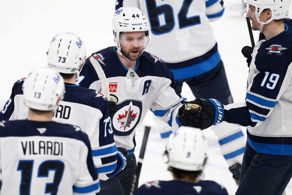 Winnipeg Jets defenseman Josh Morrissey (44) celebrates his game-winning goal during overtime of an NHL hockey game against the Washington Capitals, Saturday, Feb. 1, 2025, in Washington. (AP Photo/Nick Wass)