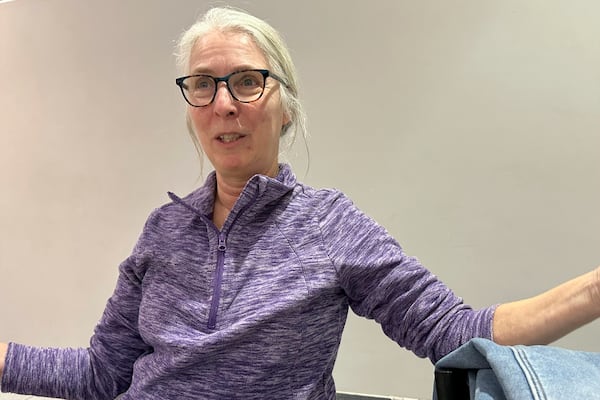 Becky Olsen, 66, is a retired teacher and administrator for deaf education who opposes Elon Musk's effort to sharply cut the federal workforce, talks Feb. 5, 2025, in Urbandale, Iowa. (AP Photo/Thomas Beaumont)