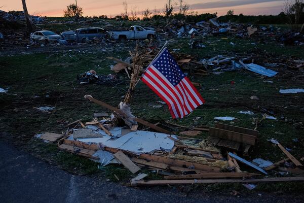FILE - An American flag is posted near destroyed homes after a tornado passed through the area on May 17, 2025, in London, Ky. (AP Photo/Carolyn Kaster, File)
