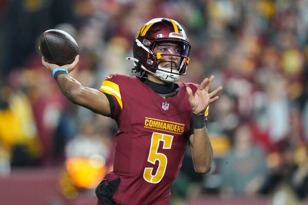 Washington Commanders quarterback Jayden Daniels (5) passes during the first half of an NFL football game against the Atlanta Falcons, Sunday, Dec. 29, 2024, in Landover. (AP Photo/Stephanie Scarbrough)