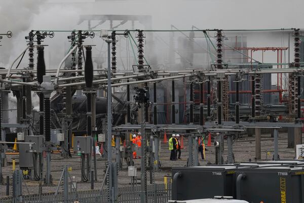 Officials walk through the North Hyde electrical substation in London on Saturday March 22, 2025, which caught fire Thursday night. (Maja Smiejkowska/PA via AP)