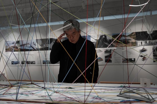 Pritzker Architecture Prize winner Chinese architect Liu Jiakun looks at an exhibition next to his office in Chengdu in southwestern China's Sichuan province on Sunday, March 2, 2025. (AP Photo/Ng Han Guan)