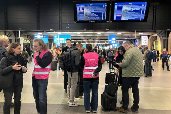 Eurostar employees help passengers as Eurostar trains to London and all trains heading to northern France have been brought to a halt following the discovery of an unexploded bomb dating back to World War II near the tracks in Paris, Friday, March 7, 2025 at the Gare du Midi station in Brussels. (AP Photo/Sylvie Corbet)