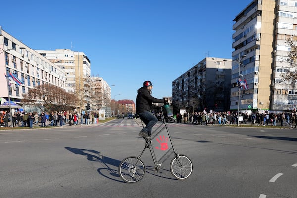 People ride motorcycles during a protest over the collapse of a concrete canopy that killed 15 people more than two months ago, in Novi Sad, Serbia, Saturday, Feb. 1, 2025. (AP Photo/Darko Vojinovic)