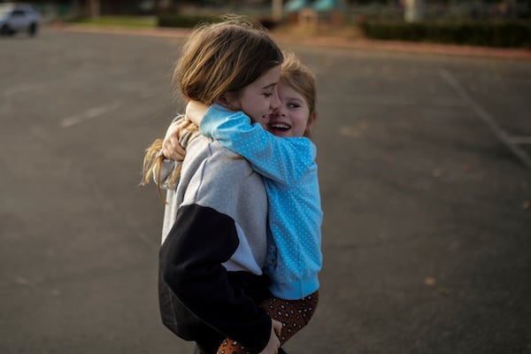 Eaton Fire evacuees Ceiba Phillips, 11, left, plays with his 4-year-old sister, Quoia, at a park in Pasadena, Calif., Wednesday, Feb. 5, 2025. (AP Photo/Jae C. Hong)