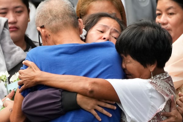 Mary Jane Veloso, center, a Filipino woman who spent almost 15 years in an Indonesian prison for drug trafficking and was nearly executed by firing squad in 2015, is reunited with her family as she arrives at the Correctional Institution for Women in Mandaluyong, Philippines Wednesday, Dec. 18, 2024. (AP Photo/Aaron Favila)