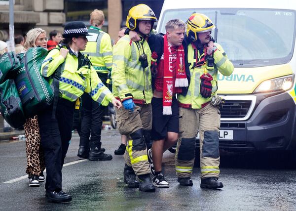 Police and emergency personnel deal with an incident on Water Street near the Liver Building in Liverpool after a car collided with pedestrians during the Premier League winners parade, in Liverpool, England, Monday May 26, 2025. (Owen Humphreys/PA via AP)